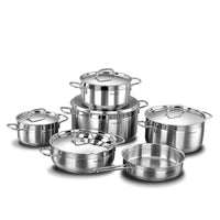 A 7-piece stainless steel cookware set with glass lids, including pots, sauté pans, and a deep stockpot, arranged on a white background.
